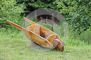 Decorative wooden cart on green grass