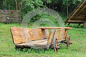 Decorative wooden cart on green grass