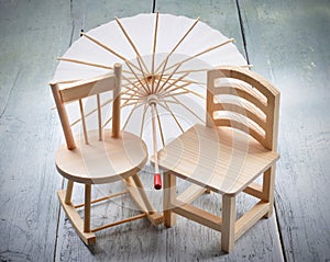 Decorative wooden chairs toys ,cocktail umbrella on a wooden