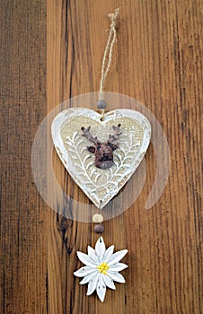 Decorative wooden heart with deer and edelweis flower