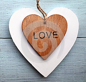 Decorative wooden hearts on a blue wooden background.Two Valentine hearts.Saint Valentine`s Day or Love concept.