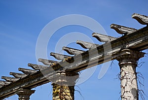 Decorative wooden trellis or pergola. wooden beam on stone and brick columns