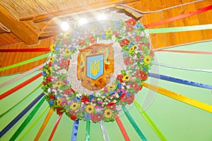 Decorative wreath decoration in the style of Ukrainian patriotism with the coat of arms and flowers