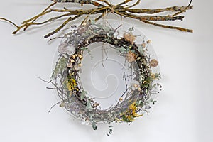 Decorative wreath of flowers and dried flowers with dry branches