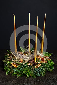 Decorative wreaths of four Advent candles in an Advent wreath decoration on a dark background. tradition before Christmas. Festive