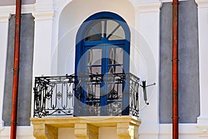 decorative wrought iron balcony balustrade. old classic building facade. white stucco elevation