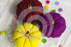 Decorative yelllow, violet and red pumpkins made from felt photo