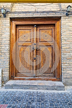 Decoratively carved wooden door in Bukhara