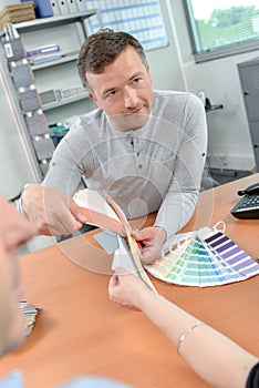 Decorator and client choosing colour
