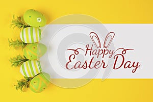 Decorted Easter eggs in a bird`s nest on a yellow background