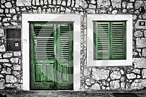 Decrepit green door and window on the Dalmatian house