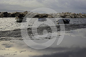 Decrepit old row boats in the harbor in Naples