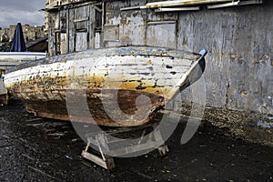 Decrepit old row boats in the harbor in Naples