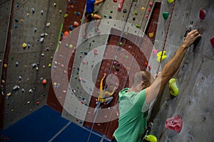 Dedicated athelets climbing wall in club