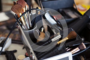 Dedicated focus Make-up converter on makeup artist's table with lots of makeup