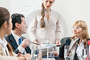 Dedicated manager sharing his opinion while interpreting a pie-chart photo