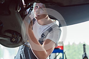 Dedicated mechanic working in a modern automobile repair shop