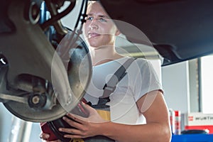 Dedicated mechanic working in a modern automobile repair shop