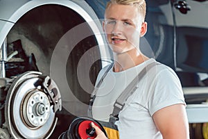 Dedicated mechanic working in a modern automobile repair shop wi photo