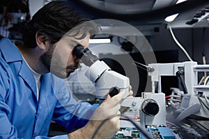 A scientist is examining samples under a microscope in a well-equipped lab for research