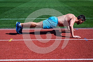 Dedicated to fitness. muscular athletic guy training. sport. male strength and power. sportsman in plank. athlete do