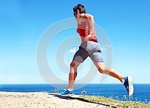Dedicated to his sport. a handsome young male athlete jogging outdoors.