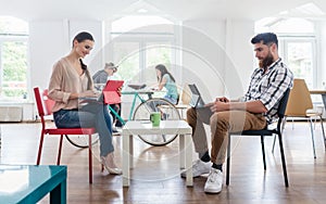 Dedicated young woman editing a document in a modern office spac photo