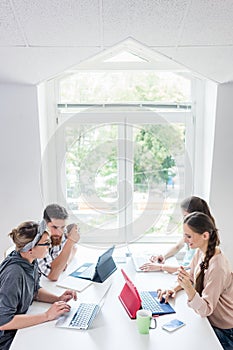 Dedicated young woman editing a document in a modern office space