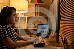 Dedicated Young Woman Studying Online Late at Night in Her Home Office