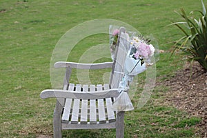 Dedication flower arrangement attached to a seaside lookout chair