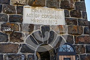 Dedication sign on the Roosevelt Arch on a bright sunny day, Yellowstone National Park, USA