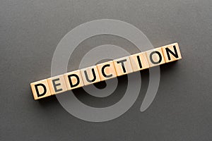 Deduction - word from wooden blocks with letters