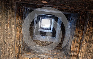 Deep ancient well. Masonry. Light at the end of the tunnel. Background