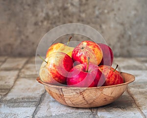 Deep bamboo cup with apples on a light table