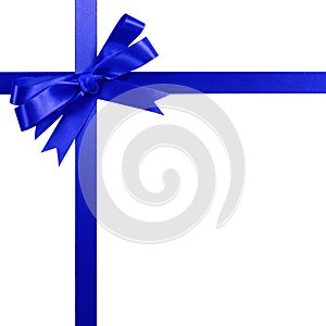 Deep blue gift ribbon bow vertical top corner border frame isolated on white