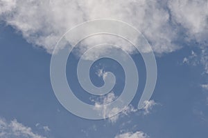 Deep blue sky background with white puffy & fluffy cumulus or cumulonimbus cloud