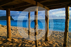 Deep blue waters of Pacific Ocean view through wooden pillars of beach fale - traditional Samoan house Lalomanu beach Samoa