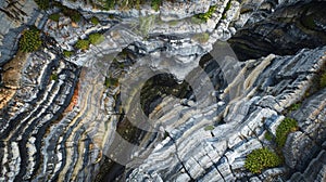 A deep chasm carved out of the earth exposes the intricate patterns and textures of the layered stones creating a