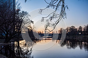 deep dark forest lake with reflections of trees and green foliage