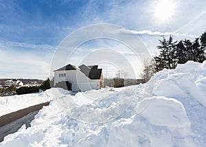 Deep drifts by side of driveway to modern home