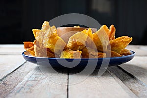 Deep fired Chinese Thai style wonton with minced pork and sweet and sour sauce in ceramic dish