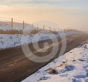 A deep fog rises from a country road in the middle of winter, 2019