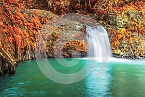 Deep forest waterfall in autumn at Sarika Waterfall World Heritage collection