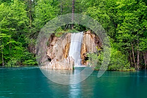 Deep forest waterfall with crystal clear water