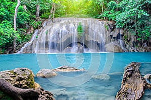 Deep forest waterfall at Erawan waterfall, beautiful waterfall with sunlight rays in deep forest, Erawan National Park