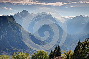 Deep forested valleys with snowy peaks in Julian Alps Slovenia