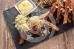 Deep Fried black rye bread with cheese salt and spices, on a plate