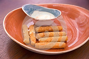 Deep fried breaded cheese sticks with tartar sauce