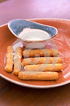 Deep fried breaded cheese sticks with tartar sauce