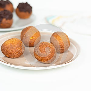 Deep fried bunuelos balls. Creative minimalist composition on a white background